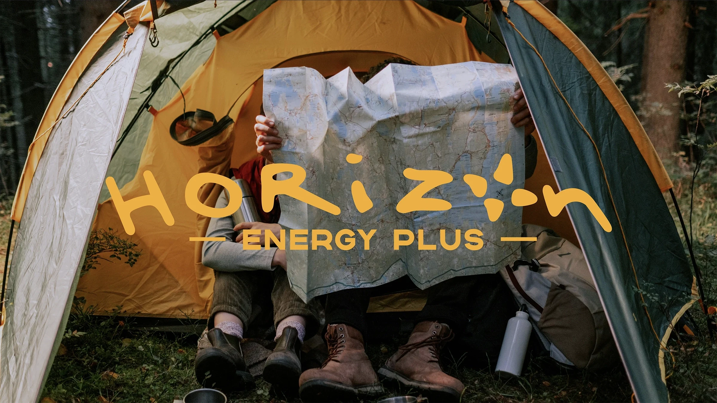 Horizon Energy Plus campaign artwork over campers studying a map inside a tent
